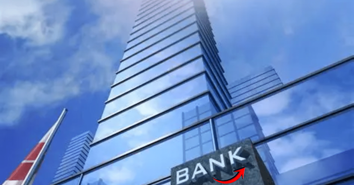 Modern glass skyscraper with a prominent “BANK” sign on the facade, viewed from below against a blue sky, symbolizing the banking sector and digital transformation.